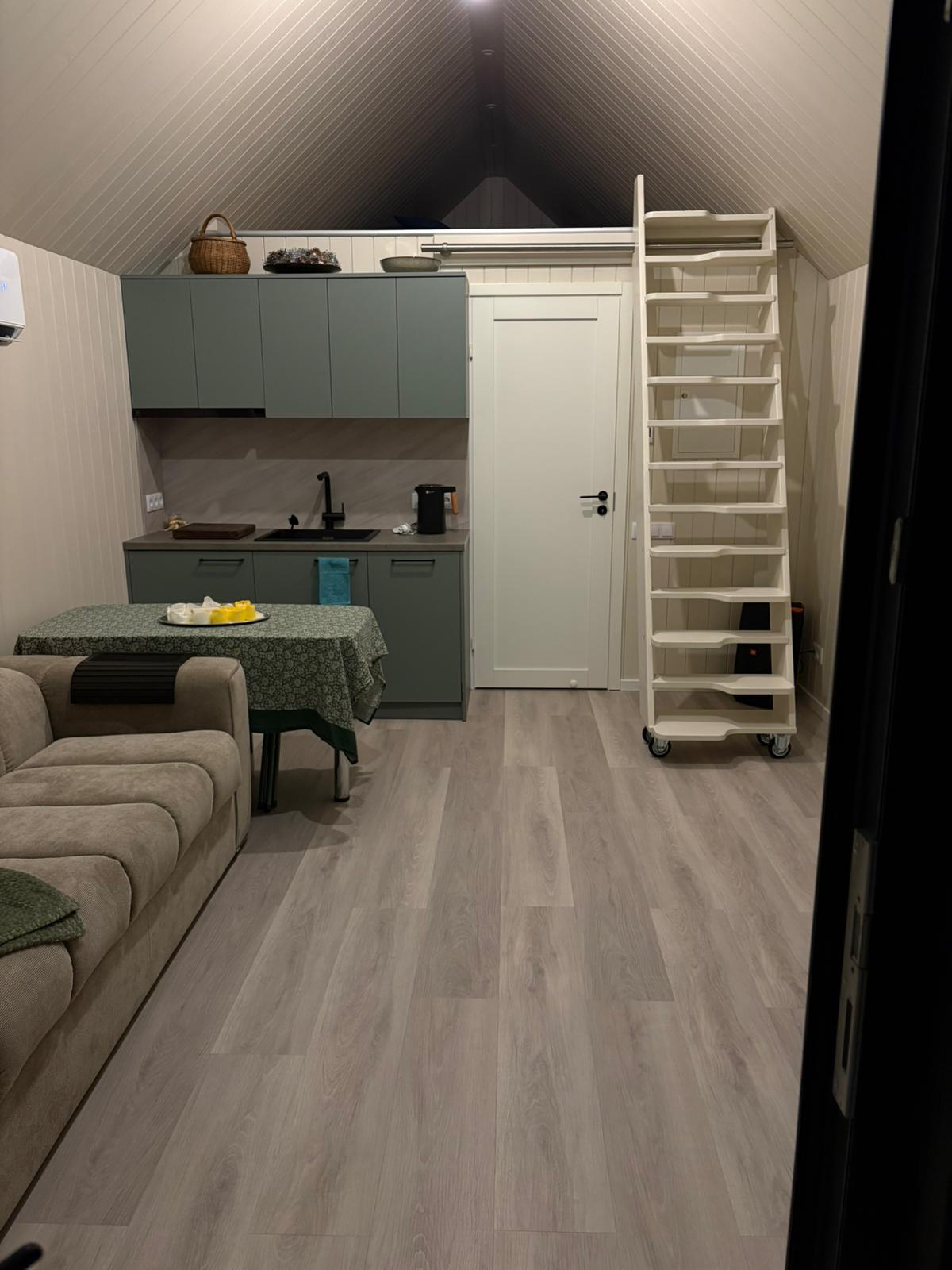Kitchen with teal cabinets and dining area